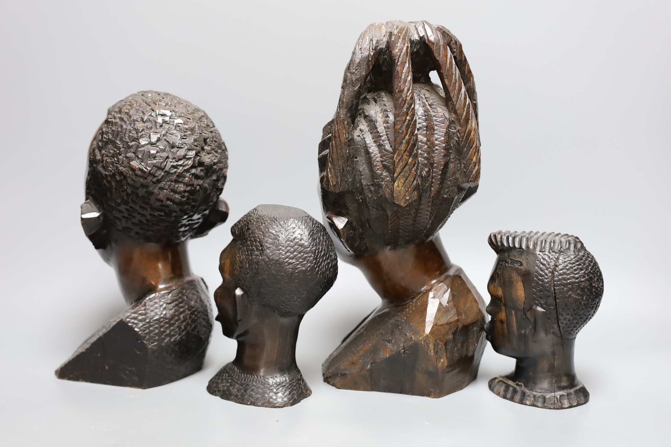 A selection of four African carved busts, Tallest 29cm